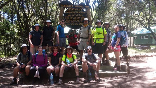 Climbers celebrating at Uhuru Peak on Mount Kilimanjaro